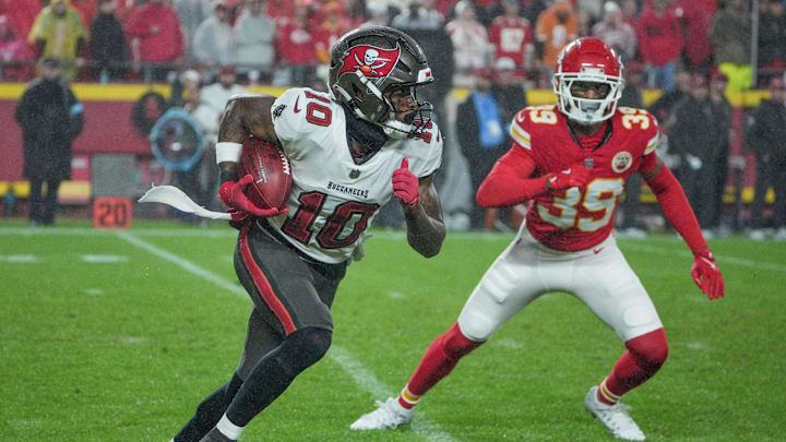 Nov 4, 2024; Kansas City, Missouri, USA; Tampa Bay Buccaneers wide receiver Trey Palmer (10) runs the ball as Kansas City Chiefs cornerback Keith Taylor Jr. (39) defends during the game at GEHA Field at Arrowhead Stadium.