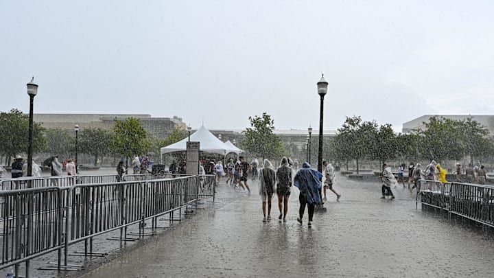 Sep 3, 2022; College Station, Texas, USA;  Fans start to leave as the rain is heavy during a weather delay of the game between the Texas A&M Aggies and the Sam Houston State Bearkats at Kyle Field. Mandatory Credit: Maria Lysaker-Imagn Images
