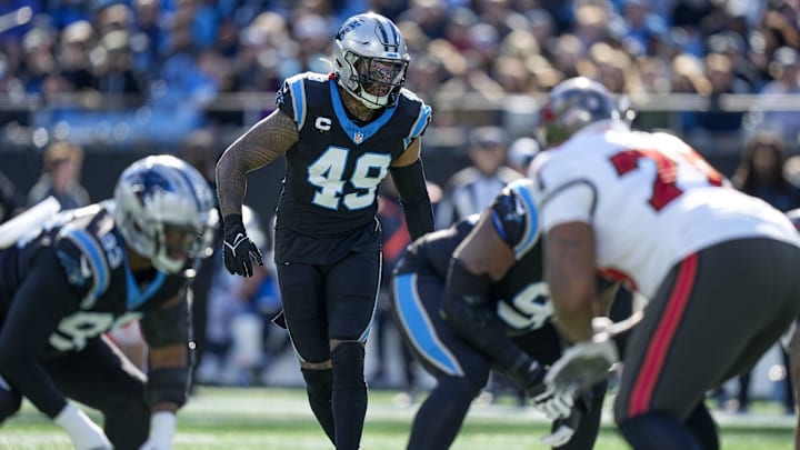 Jan 7, 2024; Charlotte, North Carolina, USA; Carolina Panthers linebacker Frankie Luvu (49) looks over the Tampa Bay Buccaneers offense during the first quarter at Bank of America Stadium. Mandatory Credit: Jim Dedmon-Imagn Images