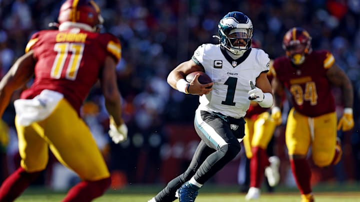 Dec 22, 2024; Landover, Maryland, USA; Philadelphia Eagles quarterback Jalen Hurts (1) against Washington Commanders safety Jeremy Chinn (11) during the first quarter at Northwest Stadium. Mandatory Credit: Peter Casey-Imagn Images