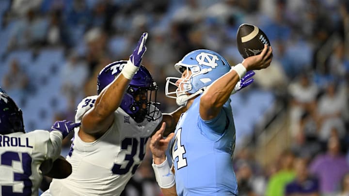 Sep 1, 2025; Chapel Hill, North Carolina, USA; North Carolina Tar Heels quarterback Max Johnson (14) passes the ball as TCU Horned Frogs defensive tackle Tristan Johnson (35) pressures in the third quarter at Kenan Stadium. Mandatory Credit: Bob Donnan-Imagn Images Sep 1, 2025; Chapel Hill, North Carolina, USA; North Carolina Tar Heels quarterback Max Johnson (14) passes the ball as TCU Horned Frogs defensive tackle Tristan Johnson (35) pressures in the third quarter at Kenan Stadium. Mandatory Credit: Bob Donnan-Imagn Images