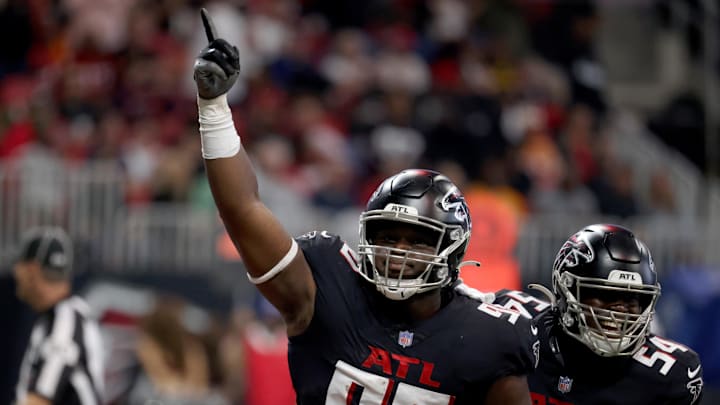 Dec 5, 2021; Atlanta, Georgia, USA; Atlanta Falcons defensive tackle Marlon Davidson (90) celebrates his interception returned for a touchdown with linebacker Foyesade Oluokun (54) during the second quarter against the Tampa Bay Buccaneers at Mercedes-Benz Stadium. Mandatory Credit: Jason Getz-Imagn Images