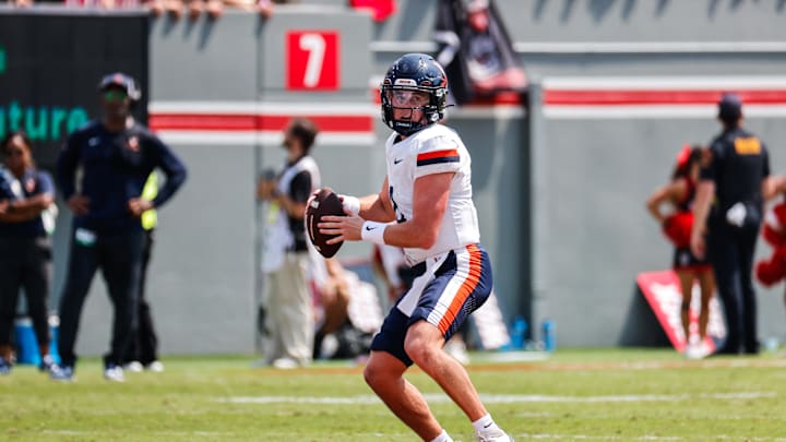 Sep 6, 2025; Raleigh, North Carolina, USA; Virginia Cavaliers quarterback Chandler Morris (4) runs with the football during the first half of the game against North Carolina State Wolfpack at Carter-Finley Stadium. Mandatory Credit: Jaylynn Nash-Imagn Images