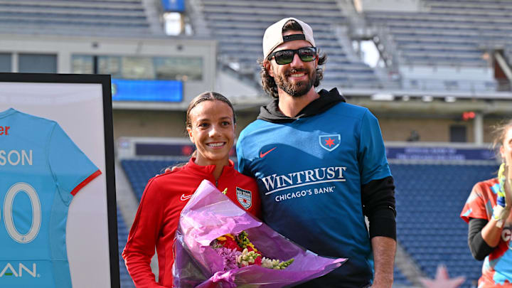 Mallory and Dansby Swanson pose during a ceremony honoring Mallory for her 100th cap. Mallory and Dansby Swanson pose during a ceremony honoring Mallory for her 100th cap.
