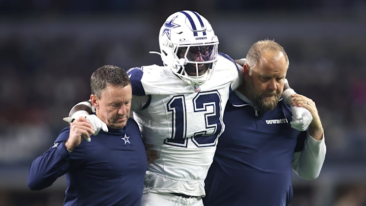Dec 9, 2024; Arlington, Texas, USA; Dallas Cowboys linebacker DeMarvion Overshown (13) is helped off the field after an injury in the second half against the Cincinnati Bengals at AT&T Stadium. Mandatory Credit: Tim Heitman-Imagn Images