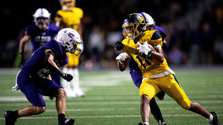 Elder defensive back Derek Uran (34) tackles Moeller wide receiver Preston Smith in the second half of the OHSAA football game between Moeller High School and Elder High School at The Pit in West Price Hill on Friday, Sept. 29, 2023.