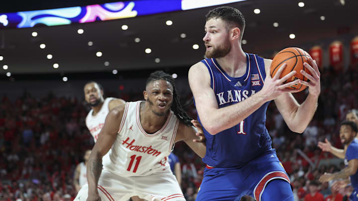 Mar 3, 2025; Houston, Texas, USA; Kansas Jayhawks center Hunter Dickinson (1) gets control of the ball away from Houston Cougars forward Joseph Tugler (11) during the second half at Fertitta Center. Mandatory Credit: Troy Taormina-Imagn Images