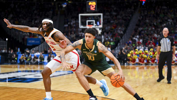 Colorado State Rams guard Nique Clifford dribbles the ball against Maryland Terrapins guard Selton Miguel.