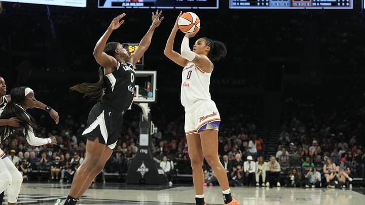 Aug 21, 2025; Las Vegas, Nevada, USA; Phoenix Mercury forward Satou Sabally (0) shoots against Las Vegas Aces guard Jackie Young (0) in the first quarter of their game at Michelob Ultra Arena. Mandatory Credit: Candice Ward-Imagn Images