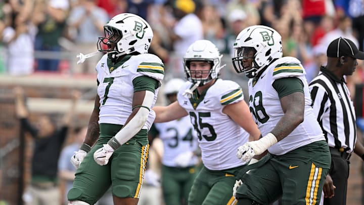 Baylor Bears running back Bryson Washington (7) and offensive lineman Omar Aigbedion (68) celebrate during the game between the SMU Mustangs and the Baylor Bears at Gerald J. Ford Stadium