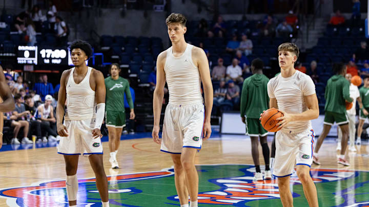 Nov 7, 2024; Gainesville, Florida, USA; Florida Gators center Olivier Rioux (32) stands between forward Sam Alexis (4) and forward Alex Condon (21) before the game against the Jacksonville Dolphins at Exactech Arena at the Stephen C. O'Connell Center. Mandatory Credit: Matt Pendleton-Imagn Images