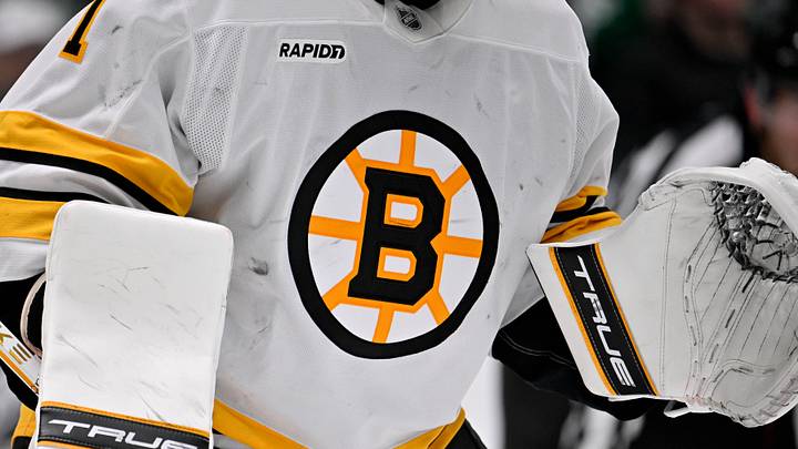 Jan 20, 2026; Dallas, Texas, USA;  A view of the Boston Bruins logo on the jersey of Boston Bruins goaltender Jeremy Swayman (1) during the game at the American Airlines Center. Mandatory Credit: Jerome Miron-Imagn Images