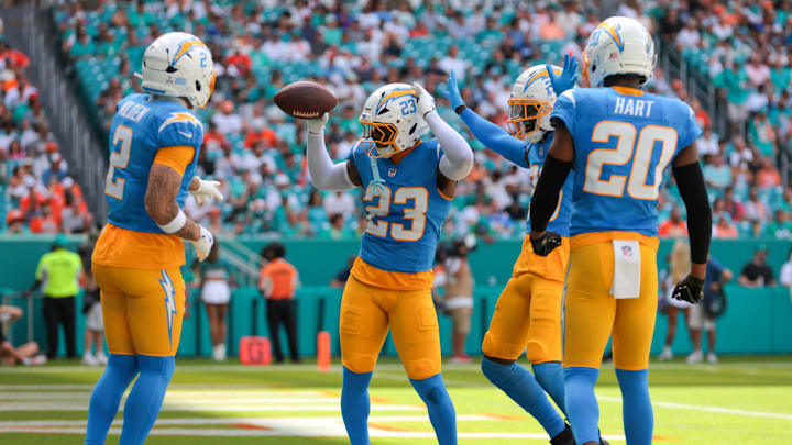 Oct 12, 2025; Miami Gardens, Florida, USA; Los Angeles Chargers safety Tony Jefferson (23) celebrates with teammates after intercepting a pass intended to Miami Dolphins wide receiver Jaylen Waddle (not pictured) during the first quarter at Hard Rock Stadium. Oct 12, 2025; Miami Gardens, Florida, USA; Los Angeles Chargers safety Tony Jefferson (23) celebrates with teammates after intercepting a pass intended to Miami Dolphins wide receiver Jaylen Waddle (not pictured) during the first quarter at Hard Rock Stadium.