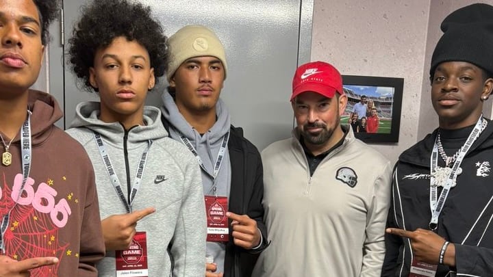 Isala Aisa Wily-Ava, middle, meets with Ohio State coach Ryan Day.