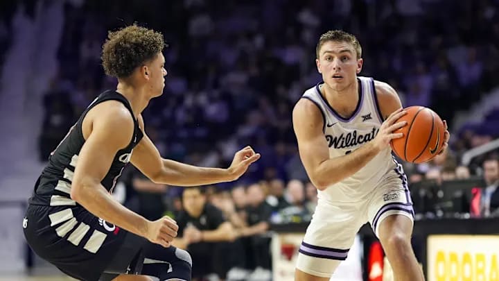 Brendan Hausen (11) has the ball while being defended by  Dan Skillings Jr. (0) in a game between the Cincinnati Bearcats in Manhattan, Kansas, USA on Dec. 30, 2024 at Bramlage Coliseum.