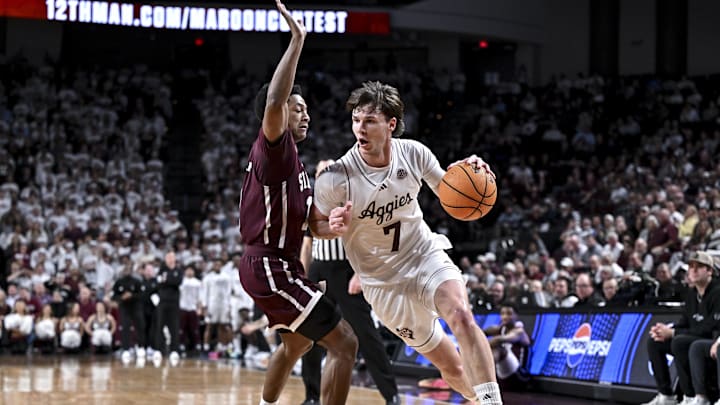 Jan 21, 2026; College Station, Texas, USA; Texas A&M Aggies forward Zach Clemence (7) drives against Mississippi State Bulldogs guard Dellquan Warren (1) during the first half at Reed Arena. Mandatory Credit: Maria Lysaker-Imagn Images 