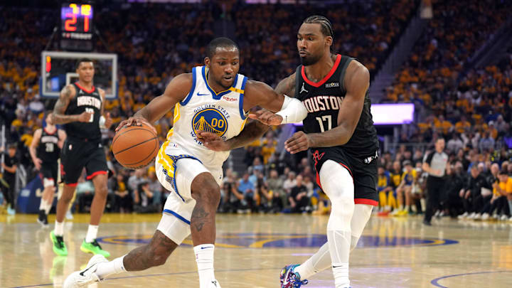Apr 26, 2025; San Francisco, California, USA; Golden State Warriors forward Jonathan Kuminga (00) dribbles against Houston Rockets forward Tari Eason (17) during the second quarter of game three of first round for the 2024 NBA Playoffs at Chase Center. Mandatory Credit: Darren Yamashita-Imagn Images