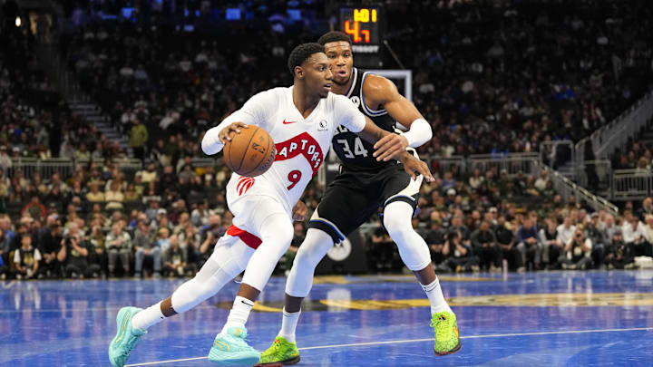 Nov 12, 2024; Milwaukee, Wisconsin, USA;  Toronto Raptors guard RJ Barrett (9) drives for the basket against Milwaukee Bucks forward Giannis Antetokounmpo (34) during the second quarter at Fiserv Forum. Mandatory Credit: Jeff Hanisch-Imagn Images