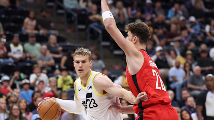 Oct 7, 2024; Salt Lake City, Utah, USA; Utah Jazz forward Lauri Markkanen (23) drives the ball against Houston Rockets center Alperen Sengun (28) during the first quarter at Delta Center. Mandatory Credit: Rob Gray-Imagn Images