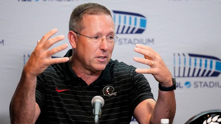 University of Cincinnati football head coach Scott Satterfield takes questions during a press conference to announce the neutral site for the upcoming Battle of the Victory Bell football game at TQL Stadium in Cincinnati on Tuesday, June 16, 2026. The rivalry college football game between the University of Cincinnati Bearcats and the Miami RedHawks will be played at TQL Stadium.