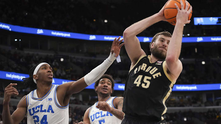 UCLA Bruins center Steven Jamerson II (24) defends Purdue Boilermakers center Oscar Cluff (45).