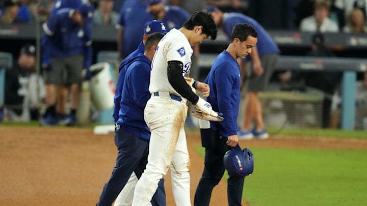 Oct 26, 2024; Los Angeles, California, USA; Los Angeles Dodgers designated hitter Shohei Ohtani (17) walks off the field after injuring his shoulder against the New York Yankees in the seventh inning for game two of the 2024 MLB World Series at Dodger Stadium. Mandatory Credit: Kirby Lee-Imagn Images Oct 26, 2024; Los Angeles, California, USA; Los Angeles Dodgers designated hitter Shohei Ohtani (17) walks off the field after injuring his shoulder against the New York Yankees in the seventh inning for game two of the 2024 MLB World Series at Dodger Stadium. Mandatory Credit: Kirby Lee-Imagn Images
