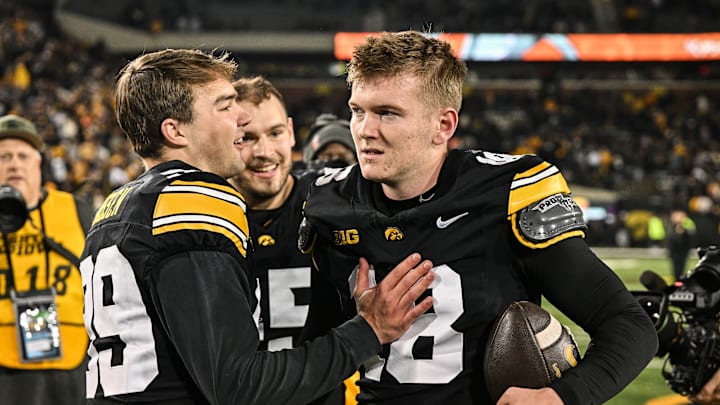 Nov 22, 2025; Iowa City, Iowa, USA; Iowa Hawkeyes kicker Drew Stevens (18) reacts with punter Ty Nissen (99) after the game against the Michigan State Spartans at Kinnick Stadium. Mandatory Credit: Jeffrey Becker-Imagn Images