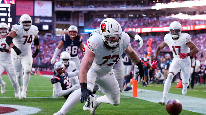 Dec 15, 2024; Glendale, Arizona, USA; Arizona Cardinals offensive tackle Jonah Williams (73) dives on a fumble for a touchdown during the first half at State Farm Stadium. Mandatory Credit: Joe Camporeale-Imagn Images