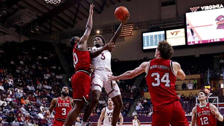 Jan 15, 2025; Blacksburg, Virginia, USA; Virginia Tech Hokies guard Jaydon Young (3) shoots the ball against North Carolina State Wolfpack guard Marcus Hill (10) during the first half at Cassell Coliseum. Mandatory Credit: Peter Casey-Imagn Images Jan 15, 2025; Blacksburg, Virginia, USA; Virginia Tech Hokies guard Jaydon Young (3) shoots the ball against North Carolina State Wolfpack guard Marcus Hill (10) during the first half at Cassell Coliseum. Mandatory Credit: Peter Casey-Imagn Images