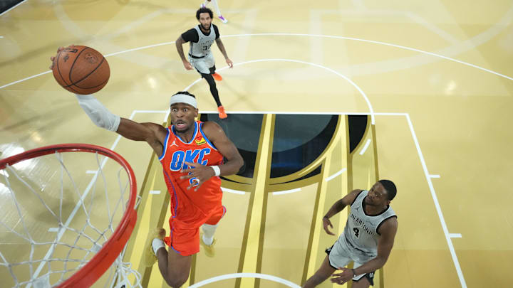 Dec 13, 2025; Las Vegas, Nevada, USA; Oklahoma City Thunder guard Shai Gilgeous-Alexander (2) goes up for the lay up as San Antonio Spurs guard De'Aaron Fox (4) looks on during the second half at T-Mobile Arena. Mandatory Credit: Kirby Lee-Imagn Images Dec 13, 2025; Las Vegas, Nevada, USA; Oklahoma City Thunder guard Shai Gilgeous-Alexander (2) goes up for the lay up as San Antonio Spurs guard De'Aaron Fox (4) looks on during the second half at T-Mobile Arena. Mandatory Credit: Kirby Lee-Imagn Images