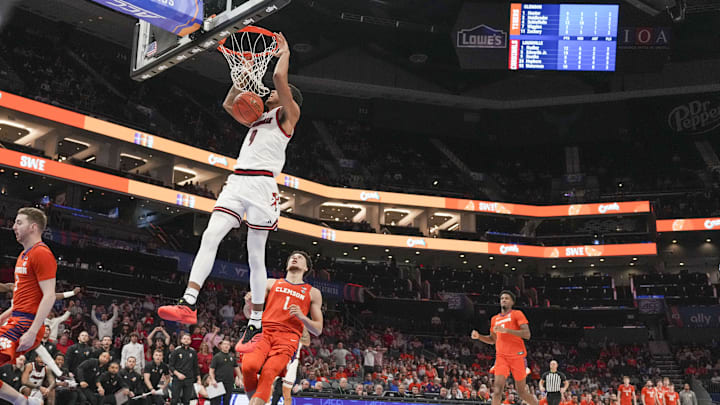 Mar 14, 2025; Charlotte, NC, USA; Louisville Cardinals guard J'Vonne Hadley (1) with a dunk over Clemson Tigers guard Chase Hunter (1) during the second half at Spectrum Center. Mandatory Credit: Jim Dedmon-Imagn Images