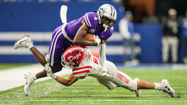 Ben Davis Giants Mark Zackery (4) is tackled by Crown Point Bulldogs Jacob Jones (5) on Saturday,