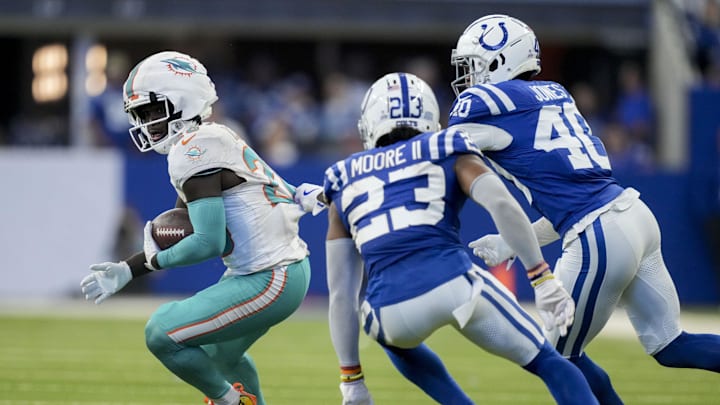 Indianapolis Colts cornerback Kenny Moore II (23) and Indianapolis Colts cornerback Jaylon Jones (40) work to bring down Miami Dolphins running back De'Von Achane (28) on Sunday, Oct. 20, 2024, during a game against the Miami Dolphins at Lucas Oil Stadium.
