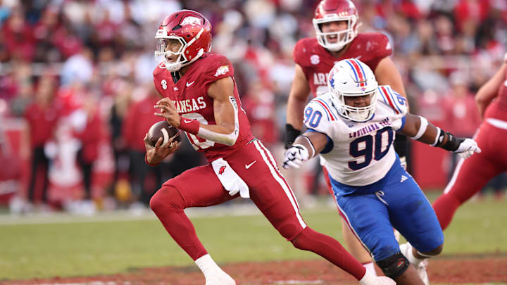 Nov 23, 2024; Fayetteville, Arkansas, USA; Arkansas Razorbacks quarterback Taylen Green (10) runs for a touchdown as Louisiana Tech Bulldogs defensive lineman David Blay (90) defends at Donald W. Reynolds Razorback Stadium. Mandatory Credit: Nelson Chenault-Imagn Images