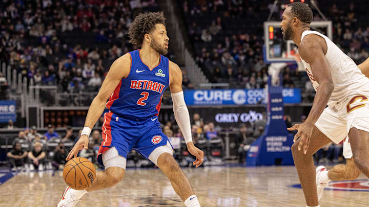 Feb 5, 2025; Detroit, Michigan, USA; Detroit Pistons guard Cade Cunningham (2) moves the ball up court on Cleveland Cavaliers forward Evan Mobley (4) during the first half at Little Caesars Arena. Mandatory Credit: David Reginek-Imagn Images