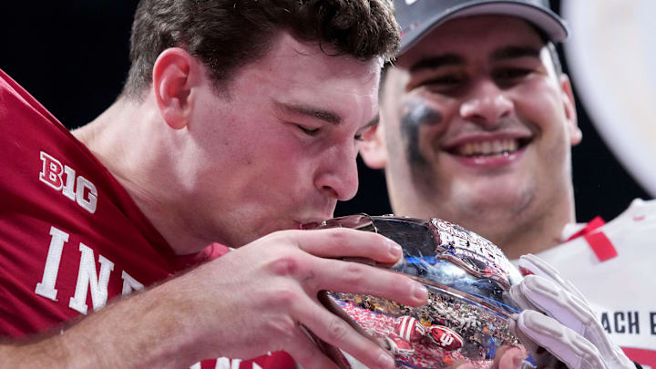 Indiana Hoosiers quarterback Fernando Mendoza (15) kisses the trophy Friday, Jan. 9, 2026, after defeating the Oregon Ducks in the Peach Bowl and semifinal game of the College Football Playoff at Mercedes-Benz Stadium in Atlanta. Indiana Hoosiers quarterback Fernando Mendoza (15) kisses the trophy Friday, Jan. 9, 2026, after defeating the Oregon Ducks in the Peach Bowl and semifinal game of the College Football Playoff at Mercedes-Benz Stadium in Atlanta.