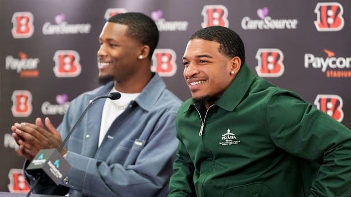 Cincinnati Bengals receivers Tee Higgins (left) and Ja’marr Chase take the stage during a press conference to announce the signing of new contracts for the pair at Paycor Stadium in downtown Cincinnati on Tuesday, March 18, 2025. Chase becomes the new highest-paid non-quarterback player in the NFL.
