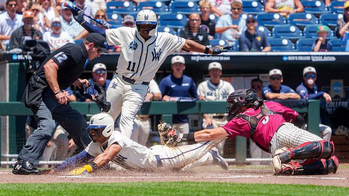 Jun 12, 2026; Omaha, NE, USA; West Virginia Mountaineers right fielder Armani Guzman (5) steals home to score against Troy Trojans catcher Jimmy Janicki (5) during the first inning at Charles Schwab Field. Jun 12, 2026; Omaha, NE, USA; West Virginia Mountaineers right fielder Armani Guzman (5) steals home to score against Troy Trojans catcher Jimmy Janicki (5) during the first inning at Charles Schwab Field.