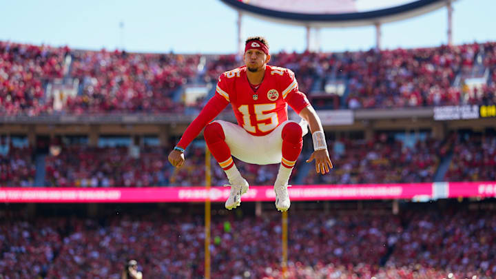 Oct 19, 2025; Kansas City, Missouri, USA; Kansas City Chiefs quarterback Patrick Mahomes (15) jumps prior to the game against the Las Vegas Raiders at GEHA Field at Arrowhead Stadium. Mandatory Credit: Jay Biggerstaff-Imagn Images