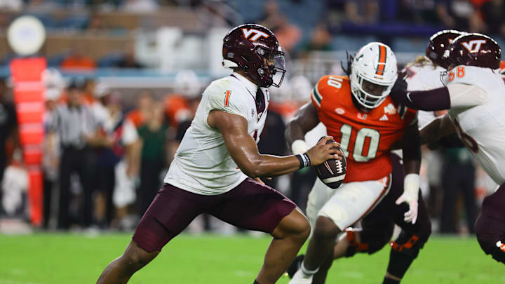 Sep 27, 2024; Miami Gardens, Florida, USA; Virginia Tech Hokies quarterback Kyron Drones (1) runs with the football against the Miami Hurricanes during the second quarter at Hard Rock Stadium. Mandatory Credit: Sam Navarro-Imagn Images