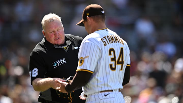 Apr 16, 2022; San Diego, California, USA; San Diego Padres relief pitcher Craig Stammen (34) is checked by umpire Bill Miller (26) during the middle of the sixth inning against the Atlanta Braves at Petco Park. Mandatory Credit: Orlando Ramirez-Imagn Images