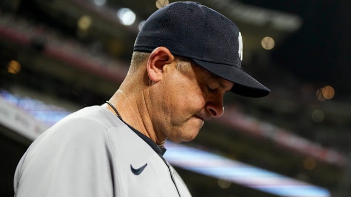 New York Yankees manager Aaron Boone (17) checks his notes before the ninth inning of the MLB interleague game between the Cincinnati Reds and the New York Yankees at Great American Ball Park in downtown Cincinnati on Monday, June 23, 2025.