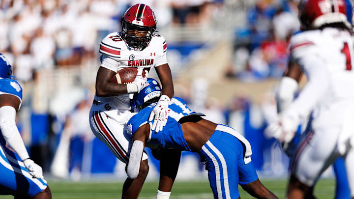 Sep 7, 2024; Lexington, Kentucky, USA; South Carolina Gamecocks tight end Michael Smith (20) is tackled by Kentucky Wildcats linebacker Daveren Rayner (17) during the third quarter at Kroger Field. Mandatory Credit: Jordan Prather-Imagn Images
