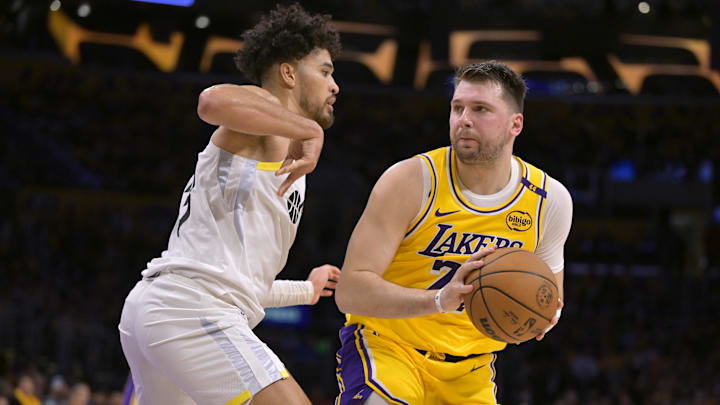 Feb 10, 2025; Los Angeles, California, USA; Los Angeles Lakers guard Luka Doncic (77) is defended by Utah Jazz guard Johnny Juzang (33) in the first half at Crypto.com Arena. Mandatory Credit: Jayne Kamin-Oncea-Imagn Images Feb 10, 2025; Los Angeles, California, USA; Los Angeles Lakers guard Luka Doncic (77) is defended by Utah Jazz guard Johnny Juzang (33) in the first half at Crypto.com Arena. Mandatory Credit: Jayne Kamin-Oncea-Imagn Images