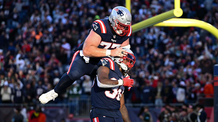 iOct 27, 2024; Foxborough, Massachusetts, USA; New England Patriots running back Rhamondre Stevenson (38) celebrates with center Ben Brown (77) after scoring a touchdown against the New York Jets during the second half at Gillette Stadium. Mandatory Credit: Brian Fluharty-Imagn Images