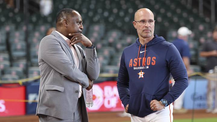 Houston Astros general manager Dana Brown (left) talks with manager Joe Espada before the game.
