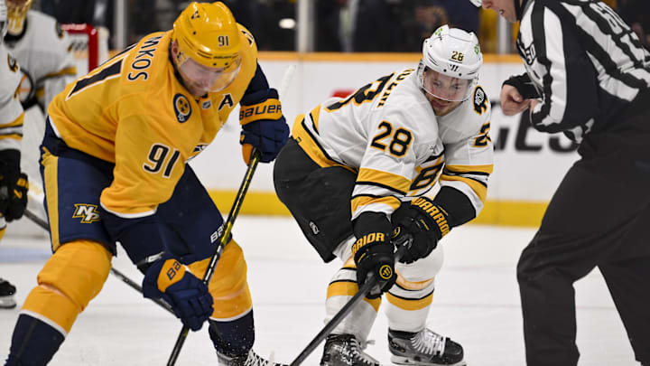 Mar 5, 2026; Nashville, Tennessee, USA;  Nashville Predators center Steven Stamkos (91) and Boston Bruins center Elias Lindholm (28) face off during the first period at Bridgestone Arena. Mandatory Credit: Steve Roberts-Imagn Images