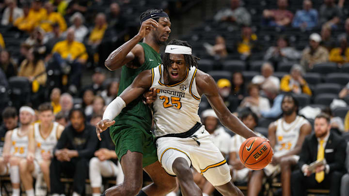 Nov 14, 2024; Columbia, Missouri, USA; Missouri Tigers guard Mark Mitchell (25) drives against Mississippi Valley State Delta Devils forward Alvin Stredic (15) during the second half at Mizzou Arena. Mandatory Credit: Jay Biggerstaff-Imagn Images