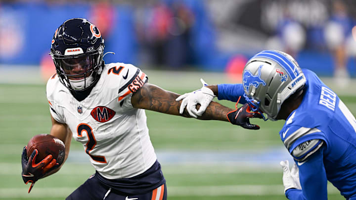 Sep 14, 2025; Detroit, Michigan, USA; Chicago Bears wide receiver DJ Moore (2) carries the ball defended by Detroit Lions cornerback D.J. Reed (4) during the first quarter of the game at Ford Field. Mandatory Credit: Lon Horwedel-Imagn Images