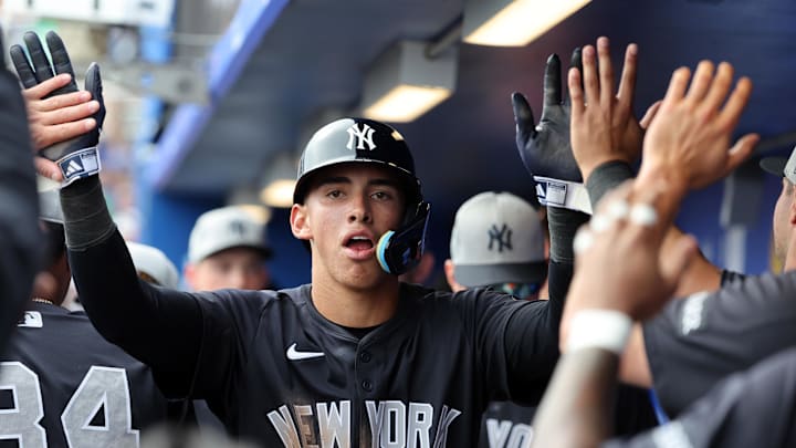 Feb 22, 2025; Dunedin, Florida, USA; New York Yankees shortstop George Lombard Jr. (96)  is congratulated after he scored a run during the sixth inning against the Toronto Blue Jays at TD Ballpark. Mandatory Credit: Kim Klement Neitzel-Imagn Images